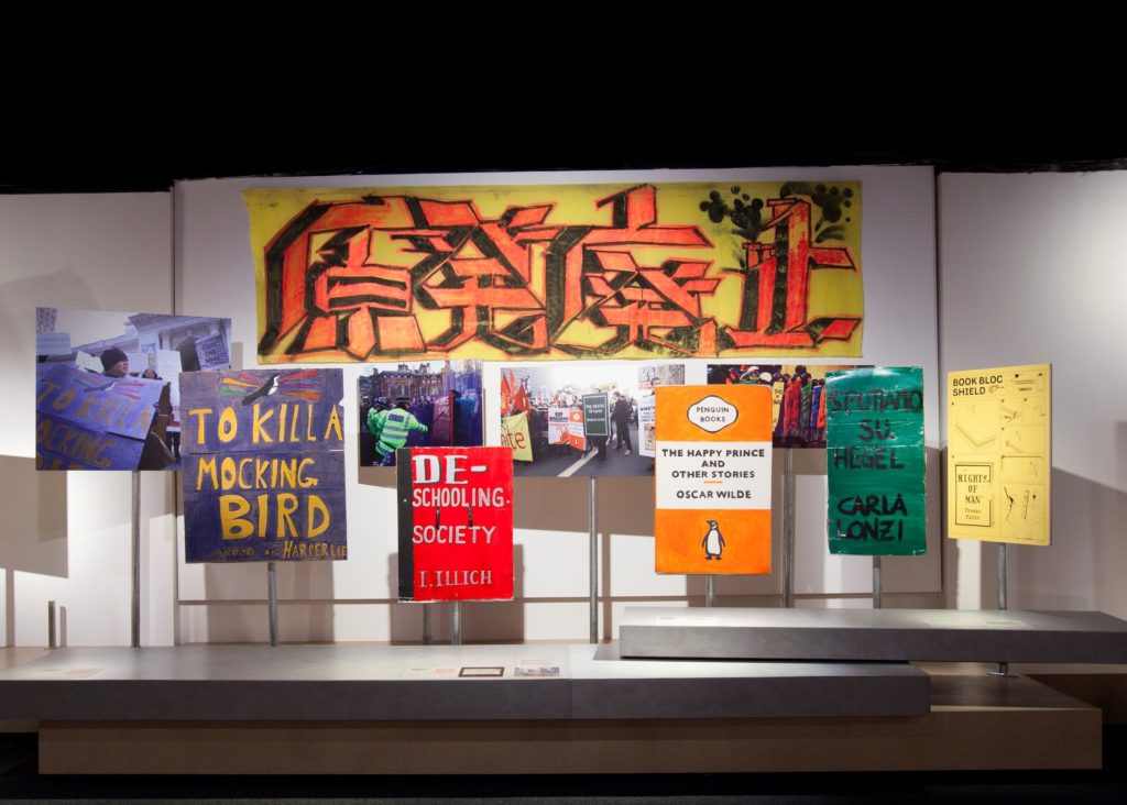 An installation view of Disobedient Objects exhibition at the Powerhouse museum, with a display of protest placards and banners